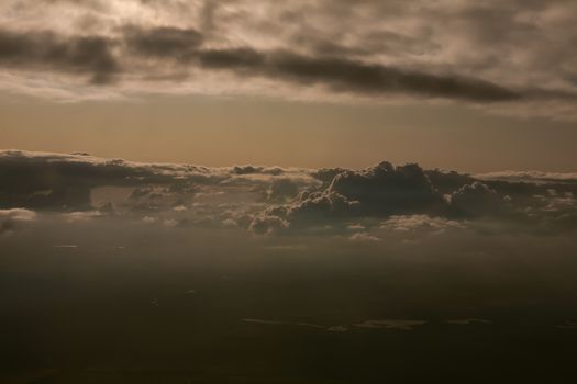 Amazing view from plane on the sky, sunset sun and clouds