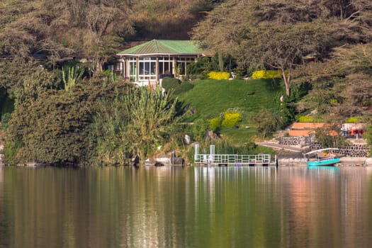 The beautiful Babogaya Lake warmly lit by the rising sun on a clear morning in Debre Zeit, Ethiopia.