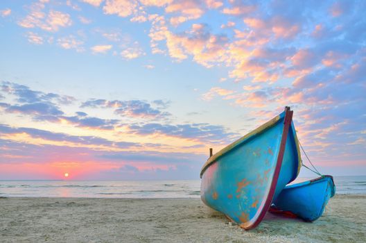 Boat on beautiful beach in sunrise on Black Sea