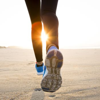 Beautiful and healthy woman running on the beach 