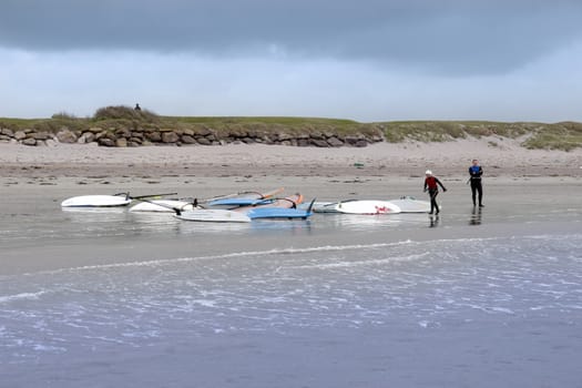 windsurfers finishing up after race and surf on the beach in the maharees county kerry ireland