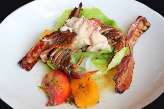 Appetizer of crab with vegetables and fried bacon