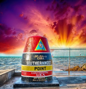 Southernmost Point sign in Key West, Florida. Beautiful seascape with sunset sky.