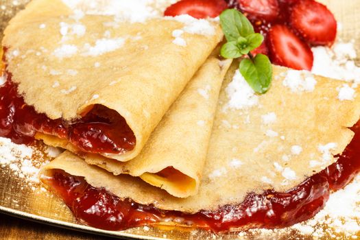 Crepes with fresh strawberries and jam