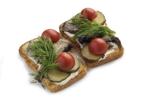 Sandwiches with sprats ,cucumbers and tomatoes isolated on white.