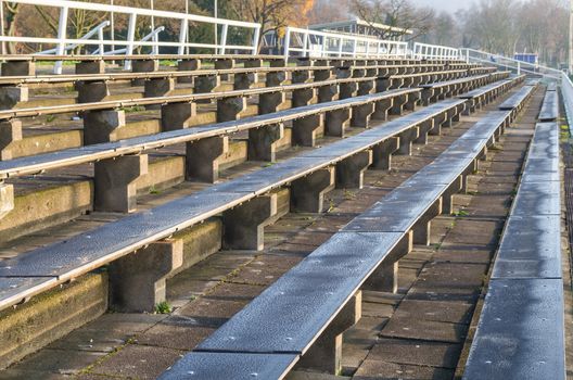 Old rows of seats, chairs, benches for a sporting event.