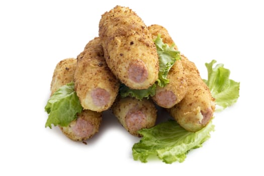 Sausages in mashed potatoes with crackers isolated on white.