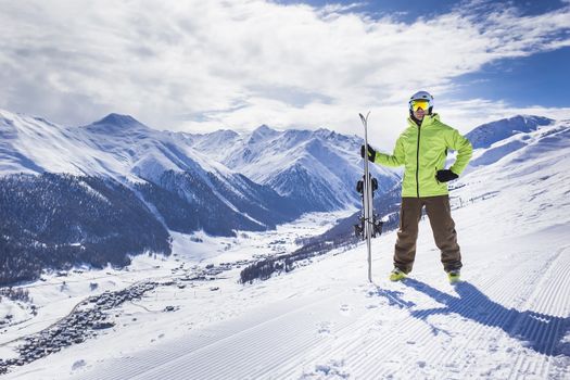 Happy successful man at apine ski slope livigno italy resort village