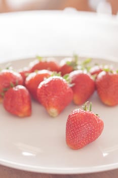 Fresh strawberries on white plate, stock photo