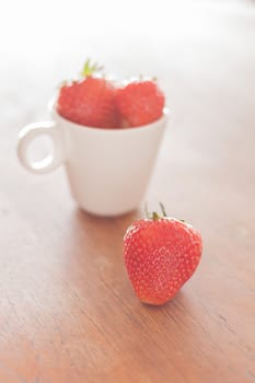 Fresh strawberries on wooden table, stock photo