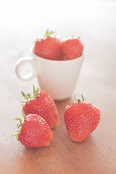 Fresh strawberries on wooden table, stock photo