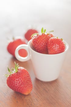 Fresh strawberries on wooden table, stock photo