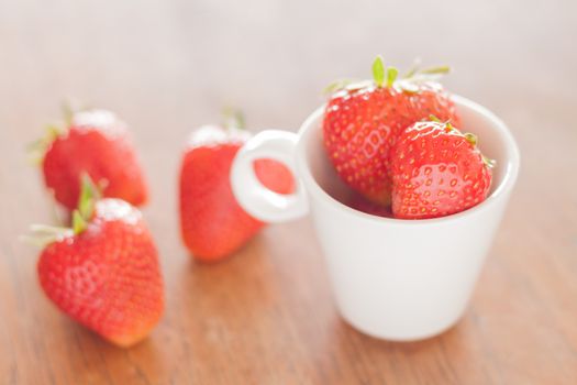 Fresh strawberries on wooden table, stock photo