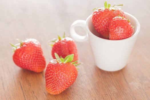 Fresh strawberries on wooden table, stock photo
