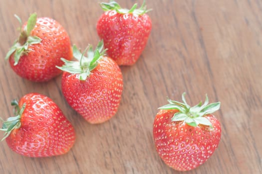 Fresh strawberries on wooden table, stock photo