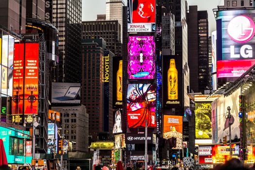 New York - Sept 2014: The glamorous streets of Times Square New York with thousands of tourists and residents are lit with giant screens displaying colorful advertisements on Sept 7, 2014 in New York, USA.