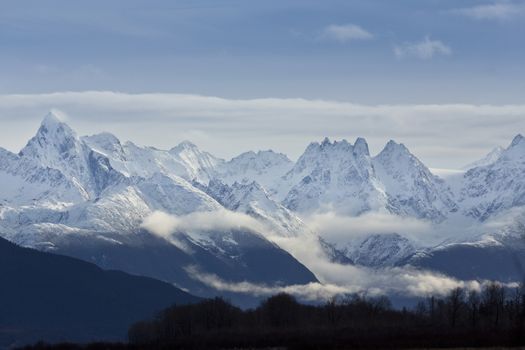 Majesty of Chilkat Mountains seen from the Haines Highway in Alaska.  The raw, towering Chilkat Mountains, part of the Coast Range of Southeast Alaska, are dramatic scenery along the Inside Passage, a route with major tourist attractions.  Chilkat Mountains are visible both from Alaska Ferry and Haines Highway. 