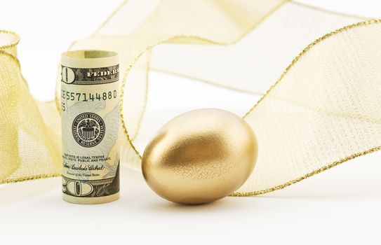 American dollar placed upright with gold nest egg and background of festive gold ribbon depicts successful outcome to investments