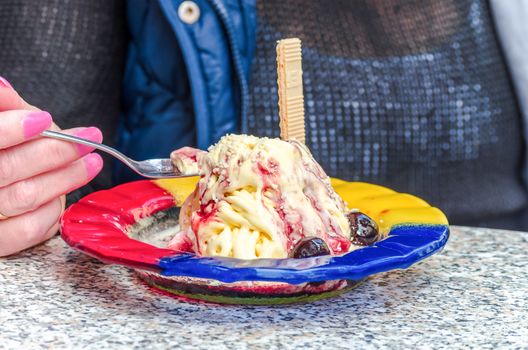 Woman in ice cream. Ice cream with waffle on a plate.