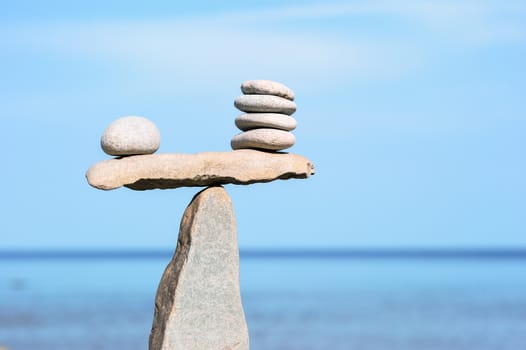 Balance of pebbles on the top of triangle stone