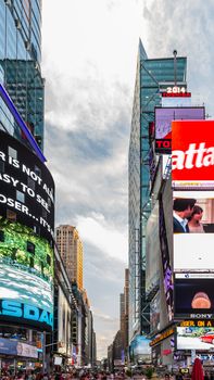 New York - Sept 2014: The glamorous streets of Times Square New York with thousands of tourists and residents are lit with giant screens displaying colorful advertisements on Sept 7, 2014 in New York, USA.