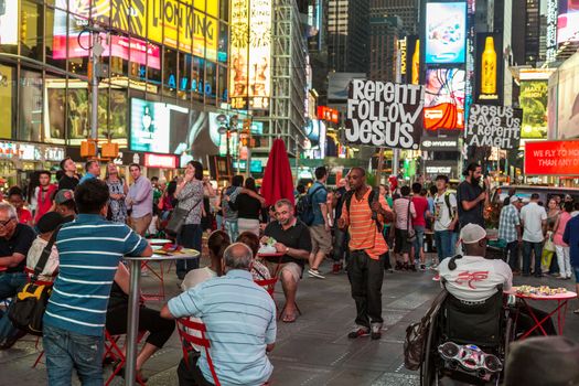 New York – Sept 2014: A man carrying a slogan which states “Repent! Follow Jesus!” for the thousands of tourists roaming the streets of Times Square on Sept 7, 2014 in New York, USA.