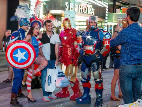 New York – Sept 2014: costumed superheroes and children's characters pose for photographs with Tourists on 42nd Street, Times Square on Sept 7, 2014 in New York, USA.