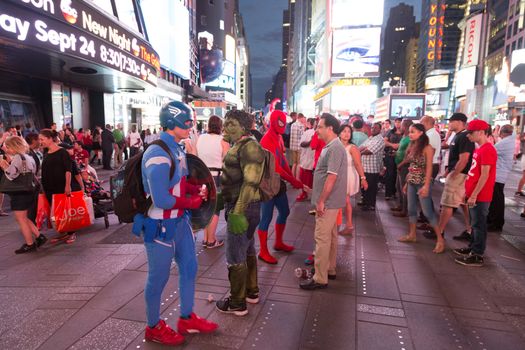 New York – Sept 2014: costumed superheroes and children's characters pose for photographs with Tourists on 42nd Street, Times Square on Sept 7, 2014 in New York, USA.