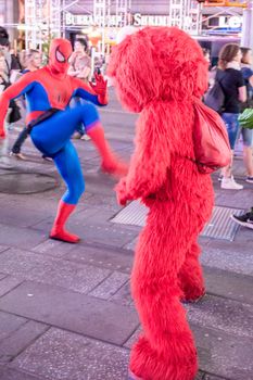 New York – Sept 2014: costumed superheroes and children's characters pose for photographs with Tourists on 42nd Street, Times Square on Sept 7, 2014 in New York, USA.