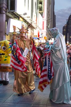 New York – Sept 2014: costumed superheroes and children's characters pose for photographs with Tourists on 42nd Street, Times Square on Sept 7, 2014 in New York, USA.