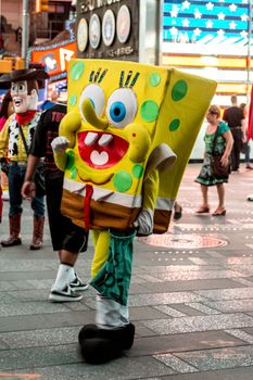 New York – Sept 2014: costumed superheroes and children's characters pose for photographs with Tourists on 42nd Street, Times Square on Sept 7, 2014 in New York, USA.