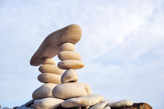 Elongated stone on the top of piles of pebbles