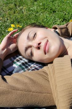 The girl in a grass. The face close-up