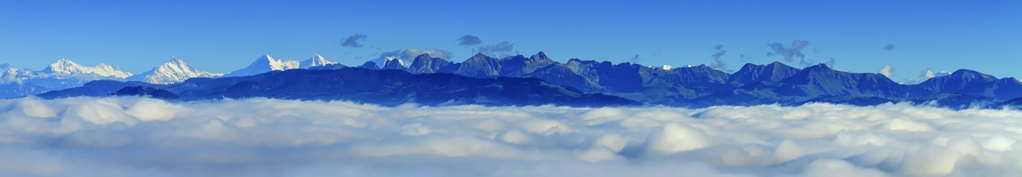 Aerial view on Alps mountains upon clouds as viwed from upon Fribourg, Switzerland