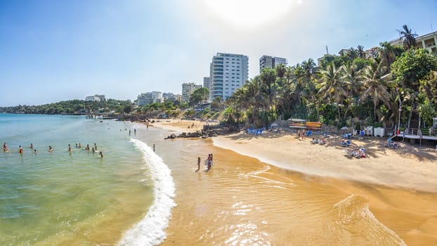 Dakar, Senegal - July 2014: Tourists and the local residents of Dakar spend their holidays on the beautiful beaches on July 11, 2014 in Dakar, Senegal