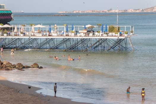 Dakar, Senegal - July 2014: Tourists and the local residents of Dakar spend their holidays on the beautiful beaches on July 11, 2014 in Dakar, Senegal