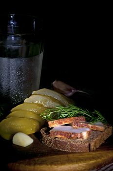 Sandwich with spiced lard served with garlic, pickled cucumber and vodka