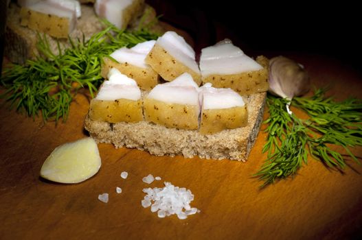 Sandwich with salted served with garlic, onion and dill