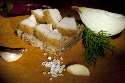 Sandwich with salted served with garlic, onion and dill