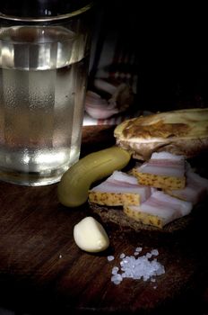 Sandwich with salted lard served with onion, cucumber, garlic and misted glass of vodka