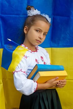 girl  in national ukrainian costume against of Ukrainian flag