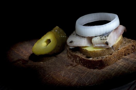 Sandwich made of herring on boiled jacket potato and rye bread