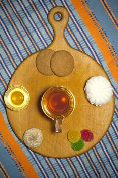 Cup of tea with sweets: oatmeal cookies, zephyr, fruit jelly, spice cake and honey