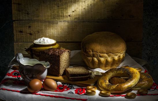 still life with black, white bread, bagels and drying