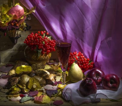 autumn still life with apple, pear, cranberry, mushroom, fallen leaves and glass of wine