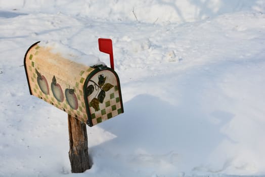 Quaint rural mailbox with red flag up indicates mail inside