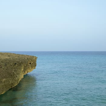 Porous sharp rocky ocean cliff