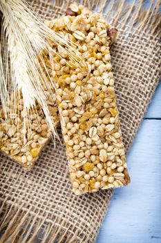 Muesli bars, cereal bars on the wooden background.