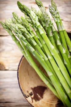 Asparagus on the wooden background.