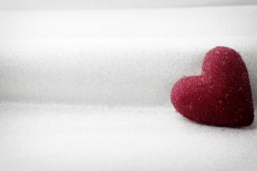 Red heart on a silver background.